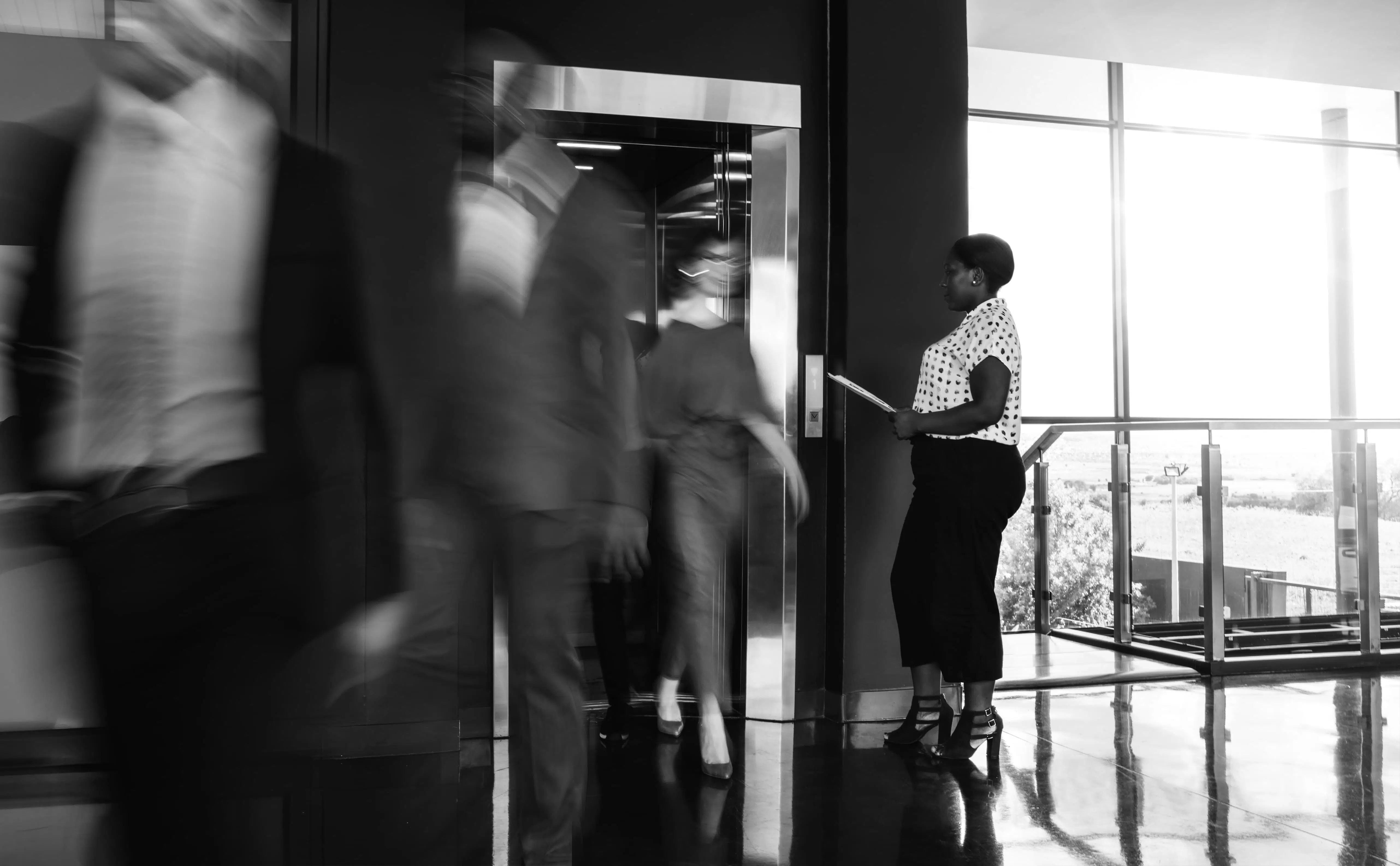 Blurred people walking out of a lift