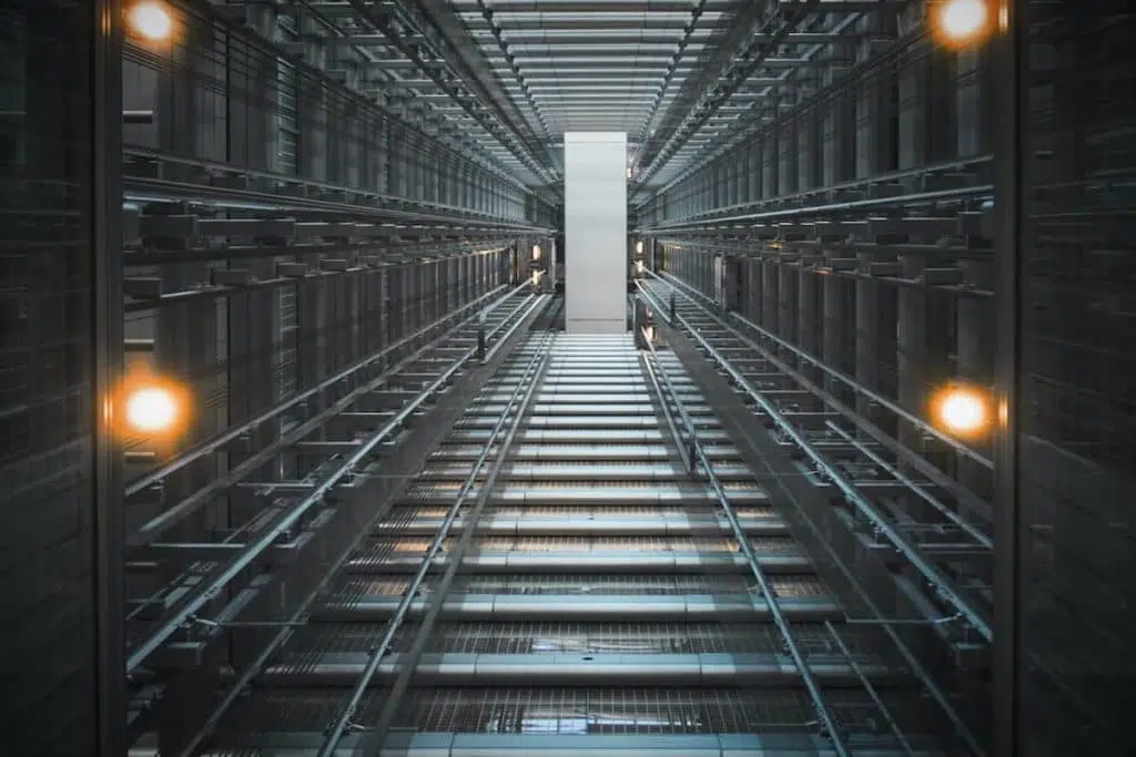 Photograph looking vertically up a lift shaft in a tall building